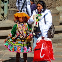 Women wearing modern clothes with daughter in tradicional garments